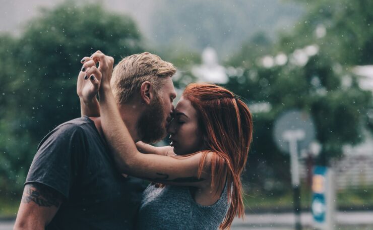 beautiful couple kissing in the rain