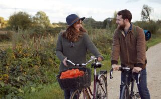 Couple enjoying cycling on marshes